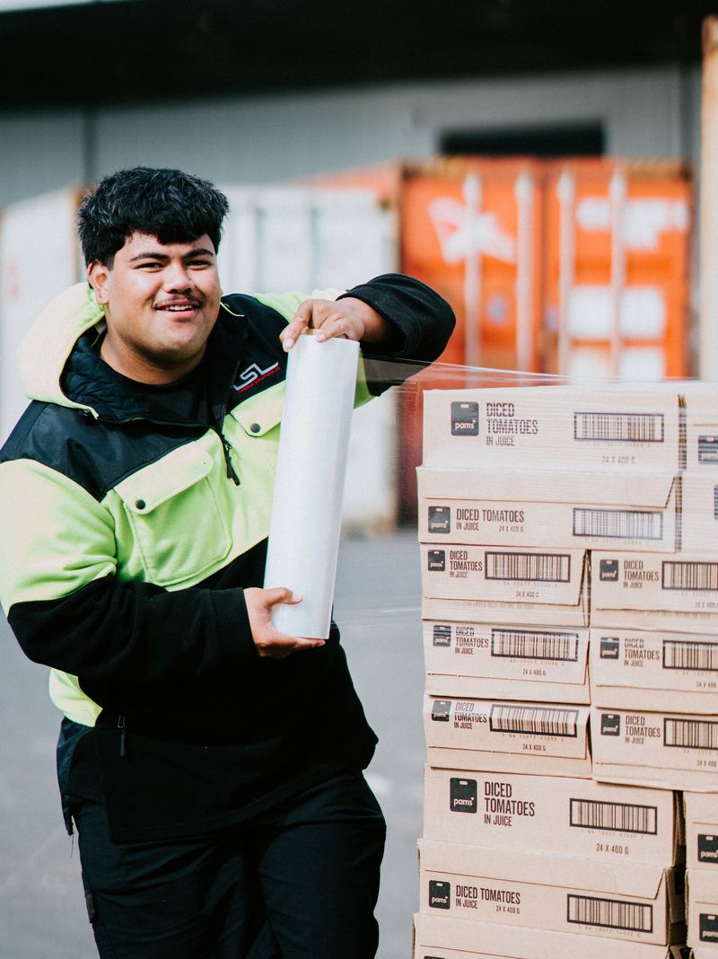 An LSL crew member wrapping a finished pallet